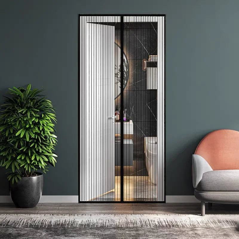 A modern glass door with vertical slats, showing an interior space and a potted plant in the foreground.