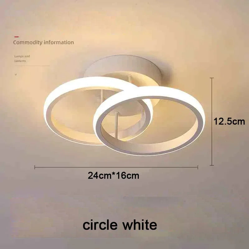 Lámpara de techo moderna LED blanca con difusor circular y pantalla cilíndrica.