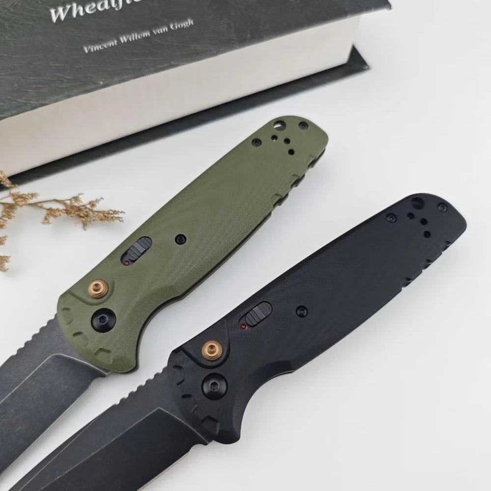 A folding utility knife with a green handle and black blade is displayed next to a book.