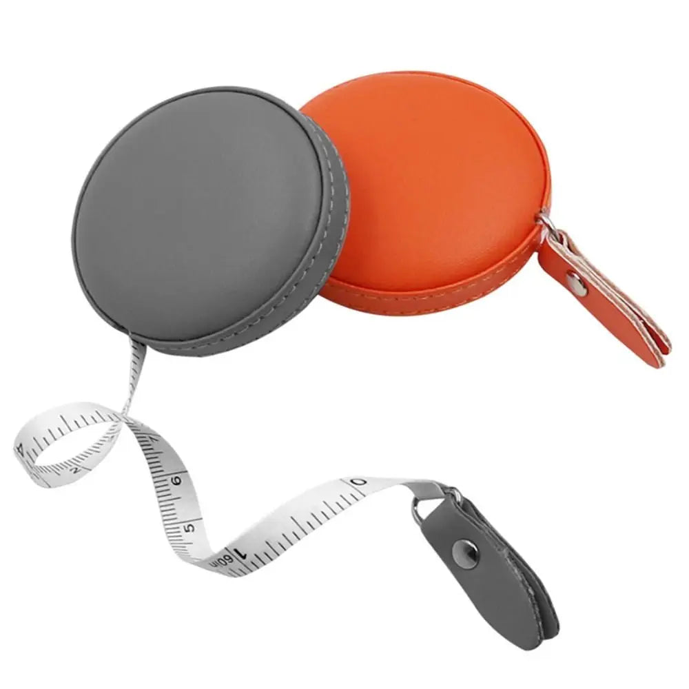 Orange and gray retractable dual scale measuring tape with a protective cover.