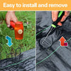 A hand installs a heavy-duty U-shaped garden staple into a black fabric, demonstrating easy installation and removal.