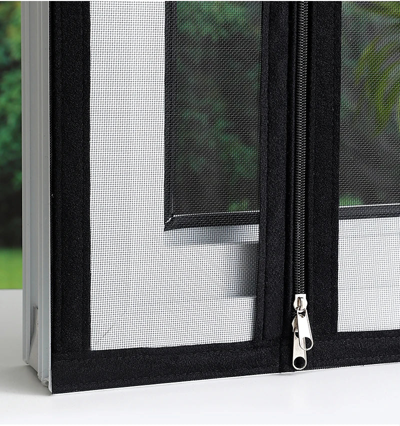A close-up view of a black window mesh screen with a self-adhesive zipper on a white frame.