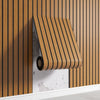 A close-up of a wooden slat wall sticker featuring a vertical pattern mounted on a white shelf.