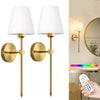 A pair of brass wall lamps with white shades and gold accents mounted on a wall.