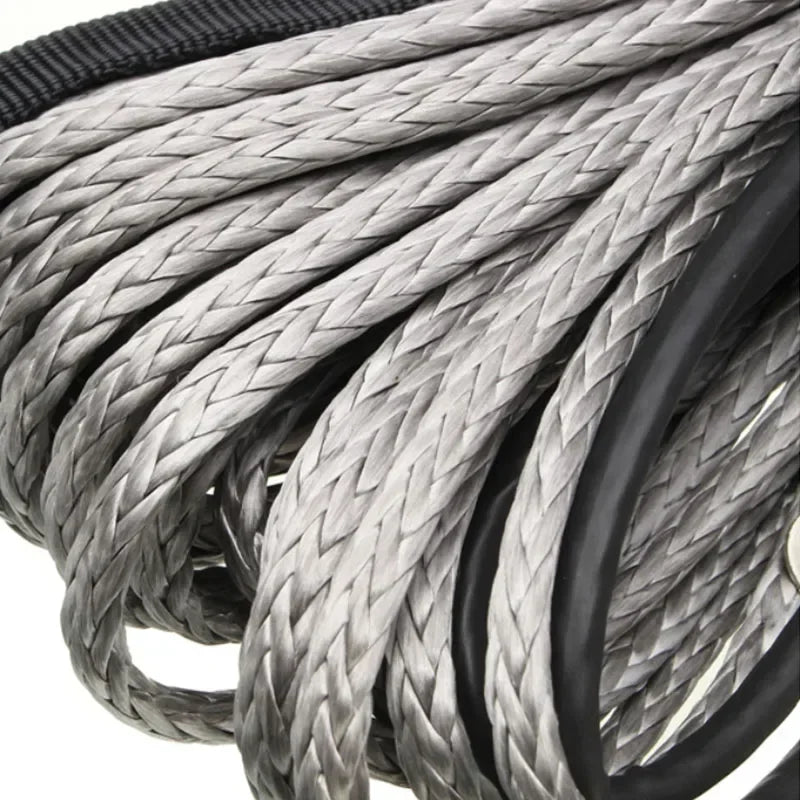 Close-up of a heavy-duty synthetic tow strap made of braided gray and black material.