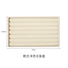 A rectangular storage tray for jewelry made of beige plush velvet with multiple horizontal slots.