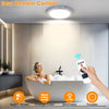 A hand holds a remote control for an LED motion sensor ceiling light installed above a bathtub.