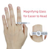 A hand demonstrates a magnifying glass ring sizer for easier reading.