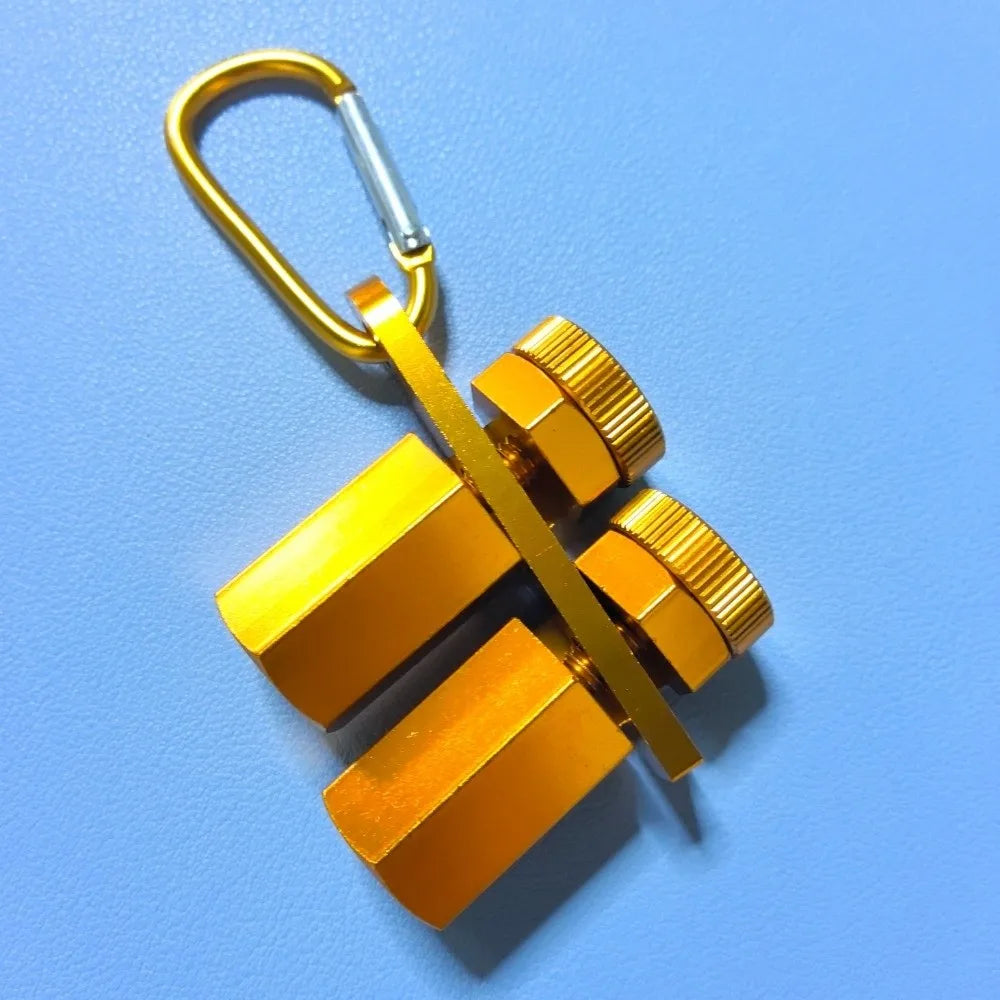 A brass precision stair gauge framing square with a loop for hanging, shown against a light blue background.