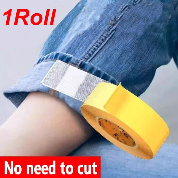 Roll of yellow fabric repair tape being applied to denim fabric.