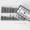 A plastic tray containing various sizes of stainless steel watch repair pins and spring bars with a measurement guide.