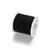 A spool of black elastic beading cord with a white core.