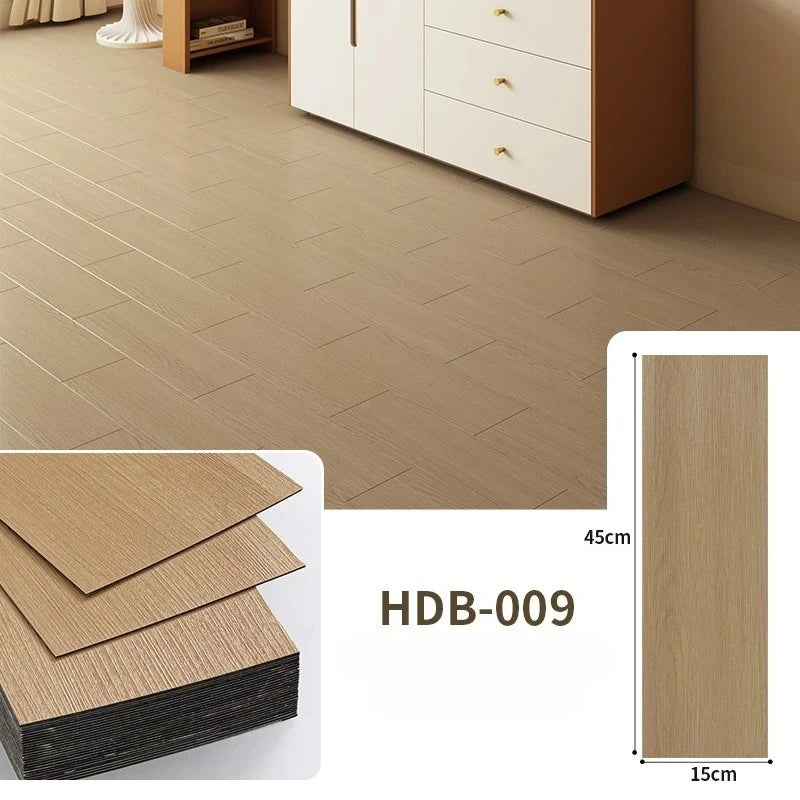 Light brown wood grain floor tiles installed on a wooden floor, showing tile dimensions and texture.
