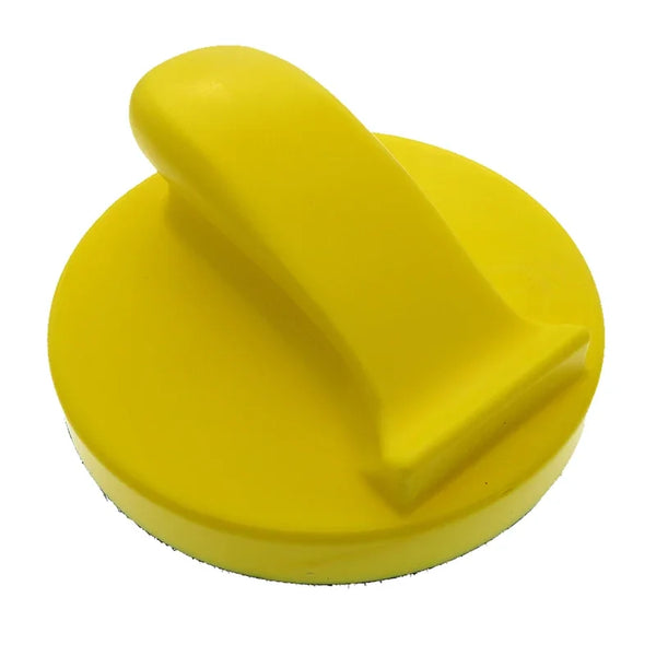 A bright yellow foam grinding block used for sanding discs.