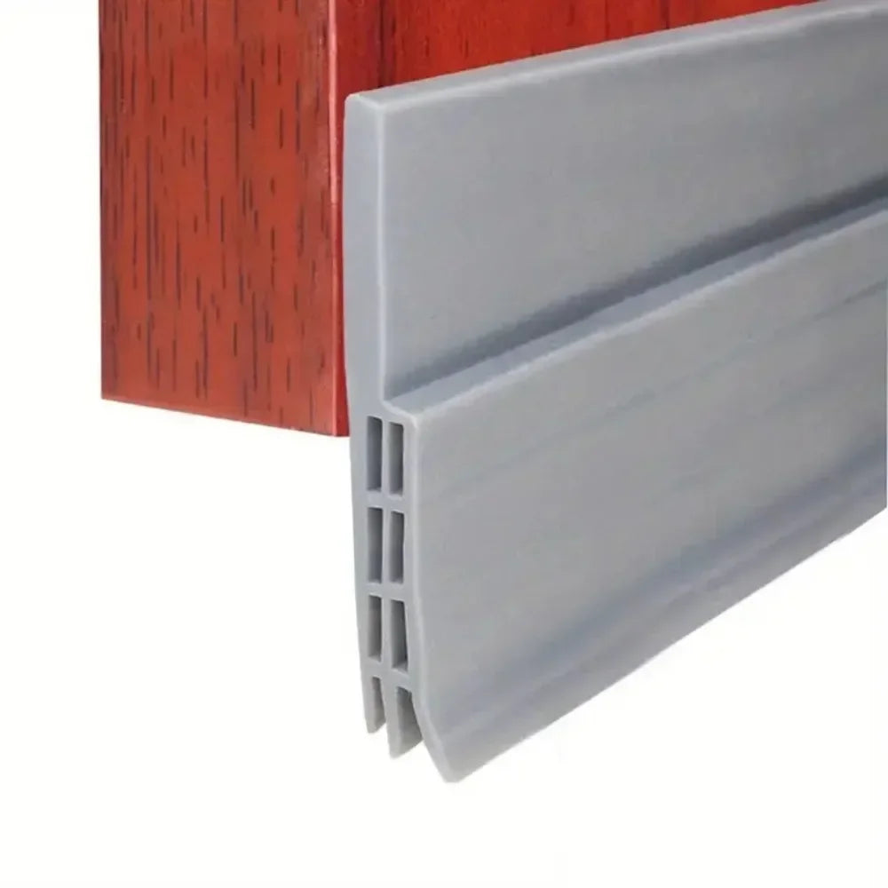 A gray door draft stopper seal strip is shown next to a reddish-brown wooden frame.