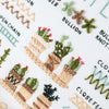 A close-up of an embroidery practice set featuring various plant motifs and textured stitches on white fabric.