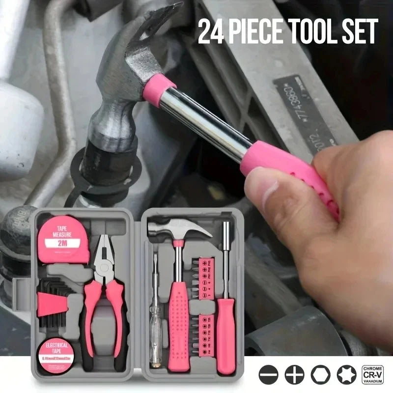 A hand holds a pink tool set box containing various repair tools like a hammer and pliers.
