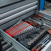 A close-up view of a gray tool organizer rack holding various hand tools and wrenches.