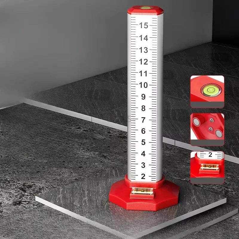 A red precision ceiling leveling tool with a vertical scale is shown on a dark gray floor.