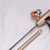 A close-up of a professional PU foam sealant spray gun with a brass body and black hose on a white surface.