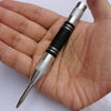 A hand holds an automatic centre punch tool with a silver body and black grip, showing the tip.