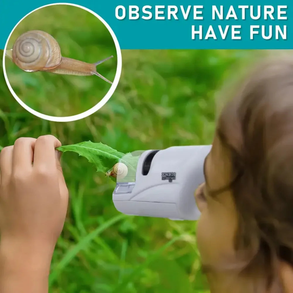 A child is using a handheld educational microscope to observe a snail in nature.