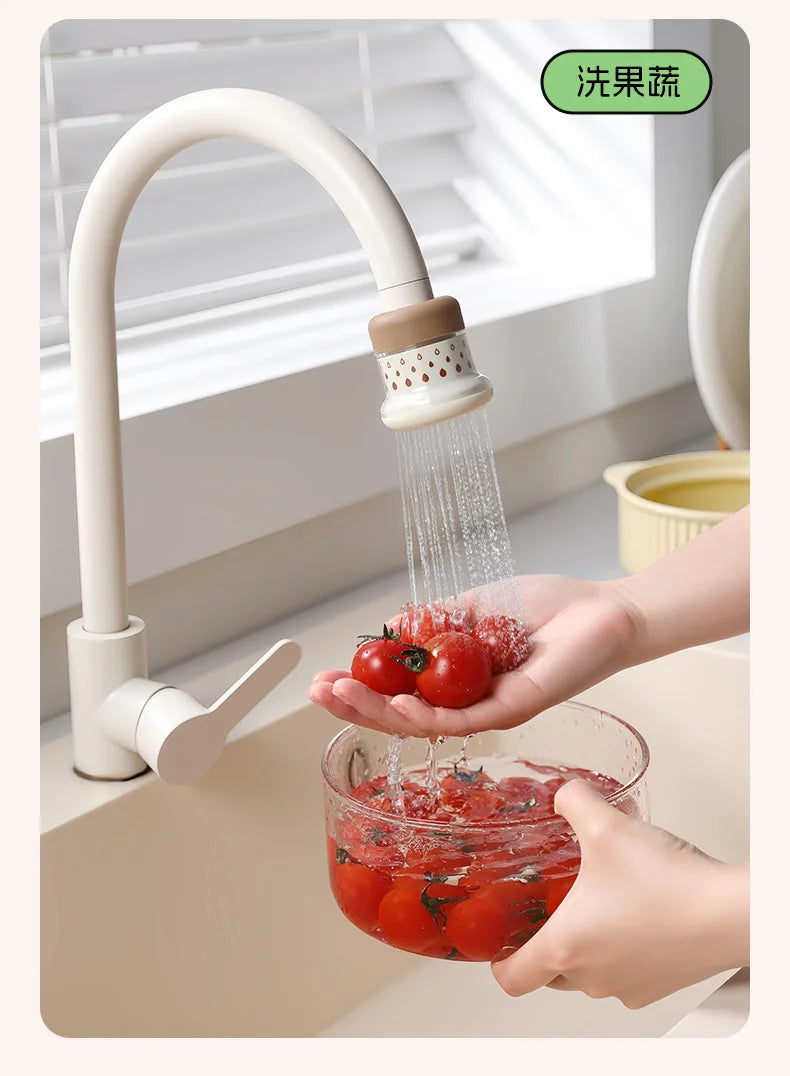 A hand is using an extendable tap filter sprayer to rinse tomatoes under a faucet.