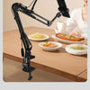 A black professional overhead lighting phone tripod is shown adjusting for full angle shooting over a table.