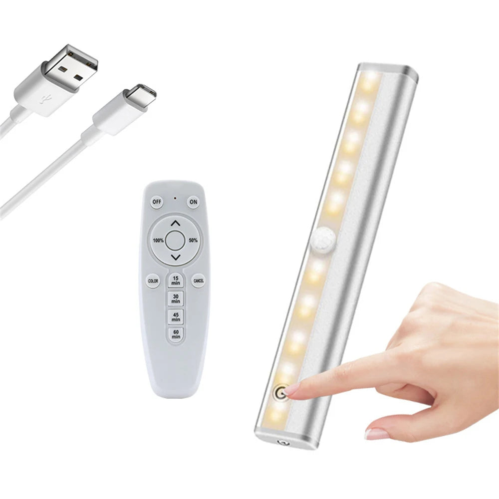 A wireless under cabinet LED light bar is shown with its remote control and a hand activating the light.