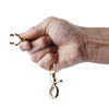 A hand holds a pair of heavy duty metal glove clips for work and outdoor use