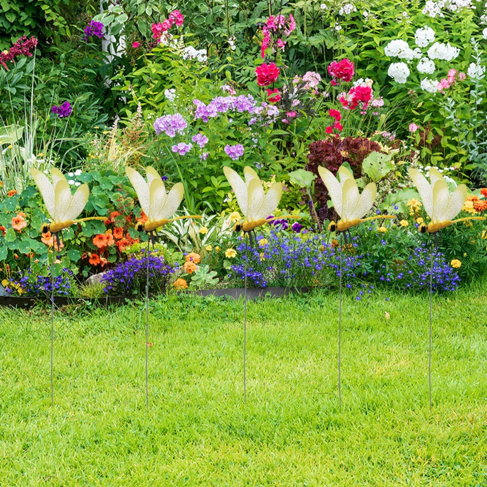 A realistic dragonfly clip is displayed among colorful garden flowers and greenery.