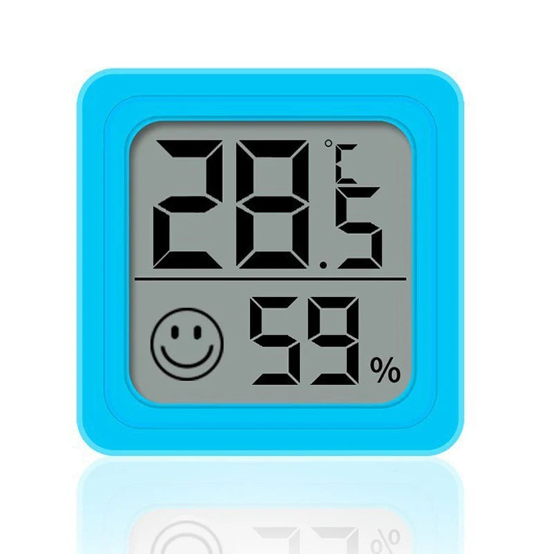 Termómetro digital azul mostrando 28.5 grados Celsius y 59 por ciento de humedad.