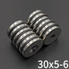 Three precision disc countersunk hole magnets with a 30x5mm size shown on a dark surface.