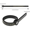 A black precision ring sizer with a magnifying element and measurement markings.