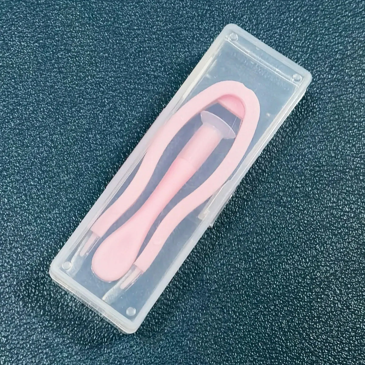 A clear plastic case containing a pink 5-piece portable contact lens tool kit.