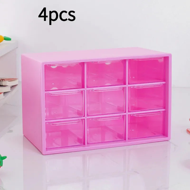 A pink multi-compartment drawer organizer with twelve clear plastic drawers is shown on a white surface.
