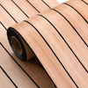 Roll of light wood veneer or plywood with black lines, showing the grain and texture.