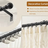 A set of matte black heavy duty curtain rods with finial heads shown mounted on a white curtain.