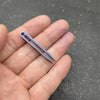 A hand holds a small, light blue titanium clip tweezers for precision use.