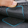 Close-up of black heavy duty self-adhesive Velcro tape being applied to a leather surface.