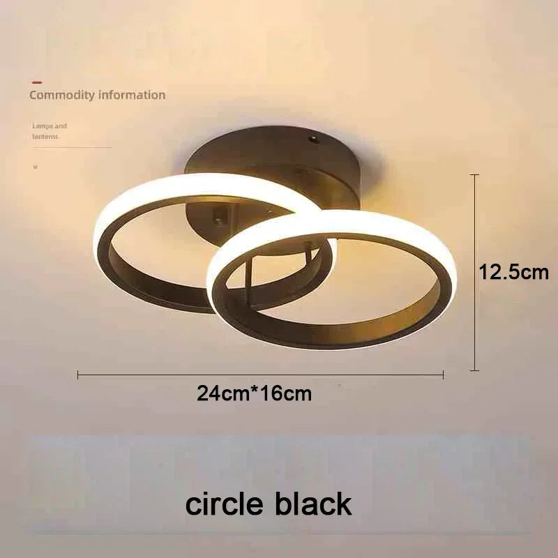 Lámpara de techo moderna LED negra con diseño circular y anillo de luz blanca.