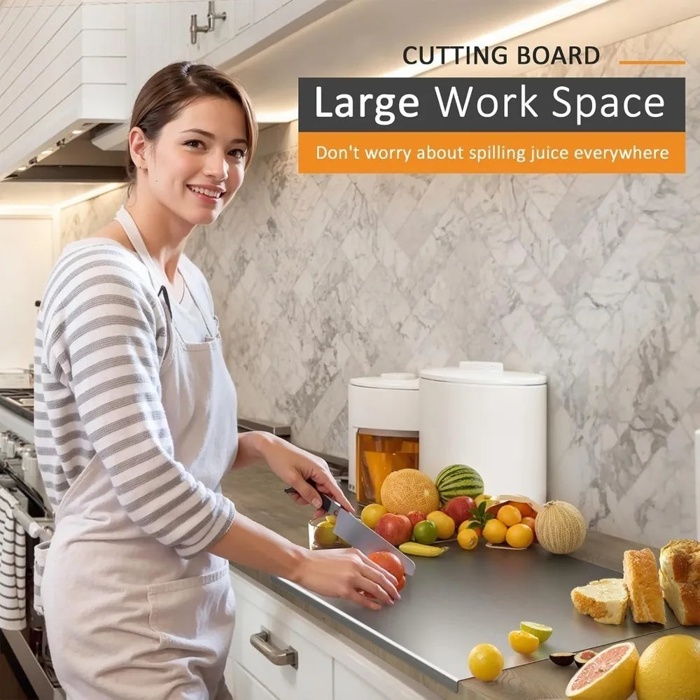 A woman is preparing food on a large stainless steel cutting board in a kitchen setting.
