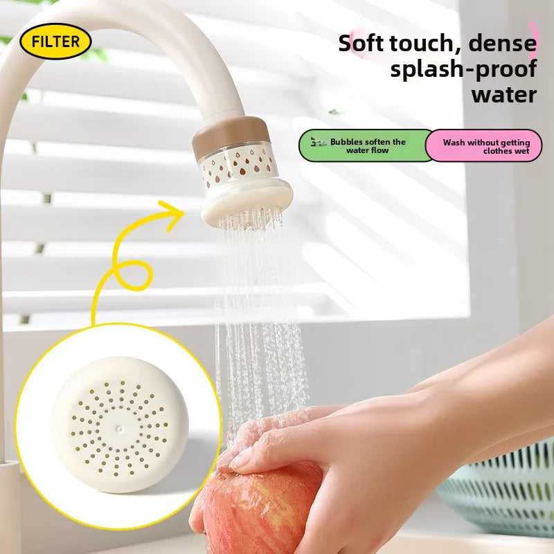 A hand is using an extendable tap filter sprayer to wash a piece of fruit, showing water flow and a filter head.