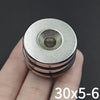 A hand holds a precision disc counter with a round, silver-colored magnetic head.