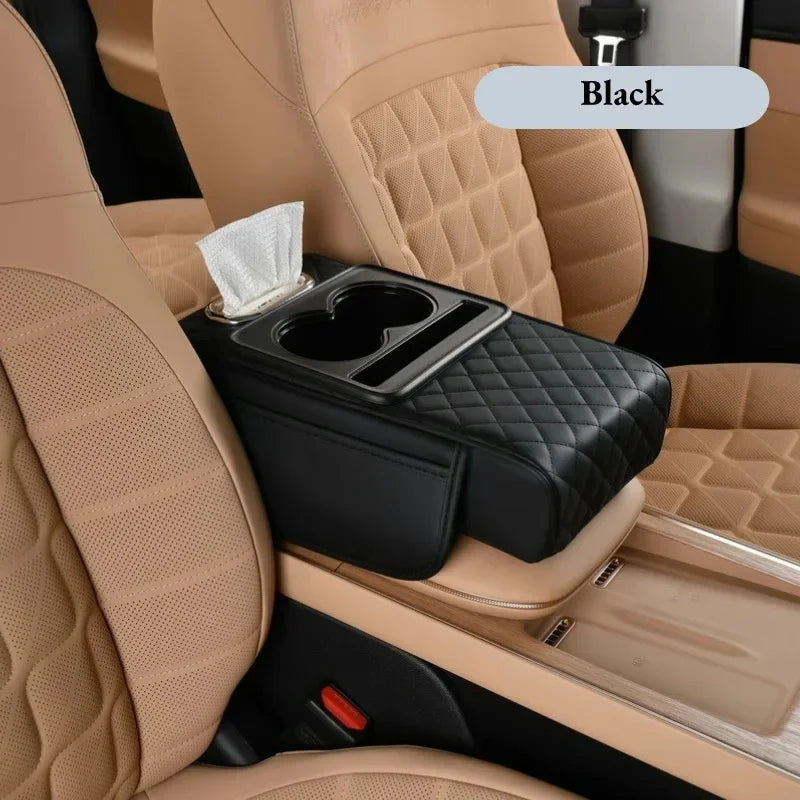 Black car armrest cushion with cup holders shown in a beige car interior.