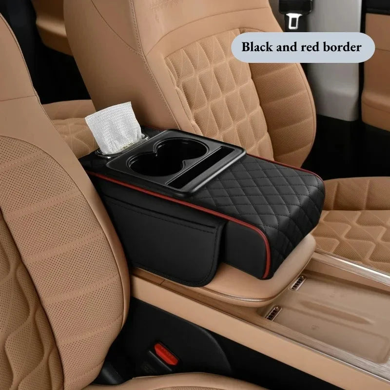 A black car armrest cushion with a red border and cup holders is placed in a beige car seat.