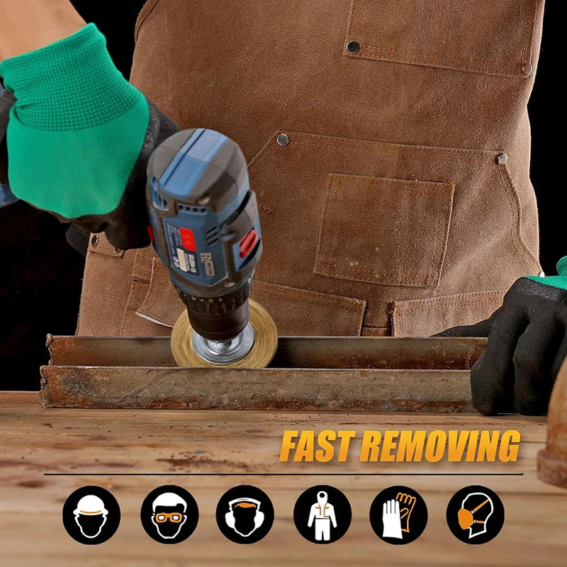 A hand is using a power tool to clean metal with a coarse crimped wire brush set on a wooden surface.