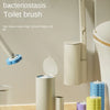 Wall-mounted toilet brush and stand set in various colors against a light wall.