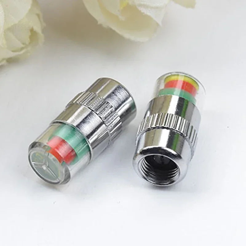 A close-up view of a 4-piece car tire pressure monitoring valve with colored indicators.
