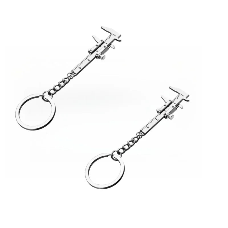 Silver metal jewelry measuring ruler and caliper keychain with a circular loop.